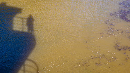 My shadow on the muddy waters of the Murray River.