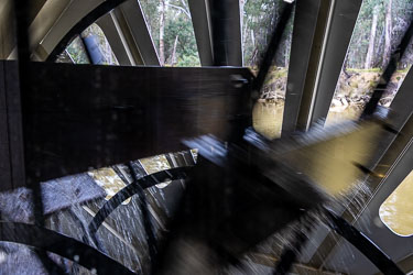 Close‑up of a paddle steamer wheel in motion aboard the Australian Star, showing blurred paddles and splashing water against the Murray River backdrop.