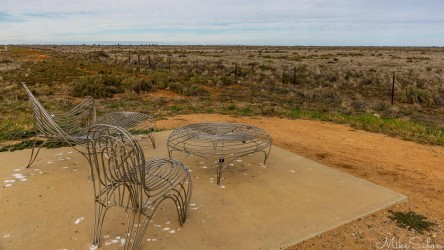 Chairs looking over empty plains at a sunset viewing spot. [1977]