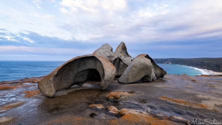 A small section of the Remarkable rock formations, a beach and cloudy sky in the background. [4088]