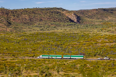 Viewed from Telstra Hill, a four car road train roars off towards Cloncurry. [7118]