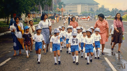 Children in blue‑and‑white uniforms walking with teachers along a Jakarta street after a parade, with civic buildings in the background.